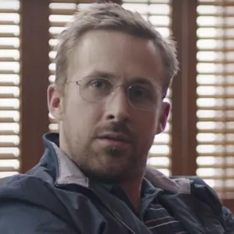 A dishevled man with glasses looking confused.